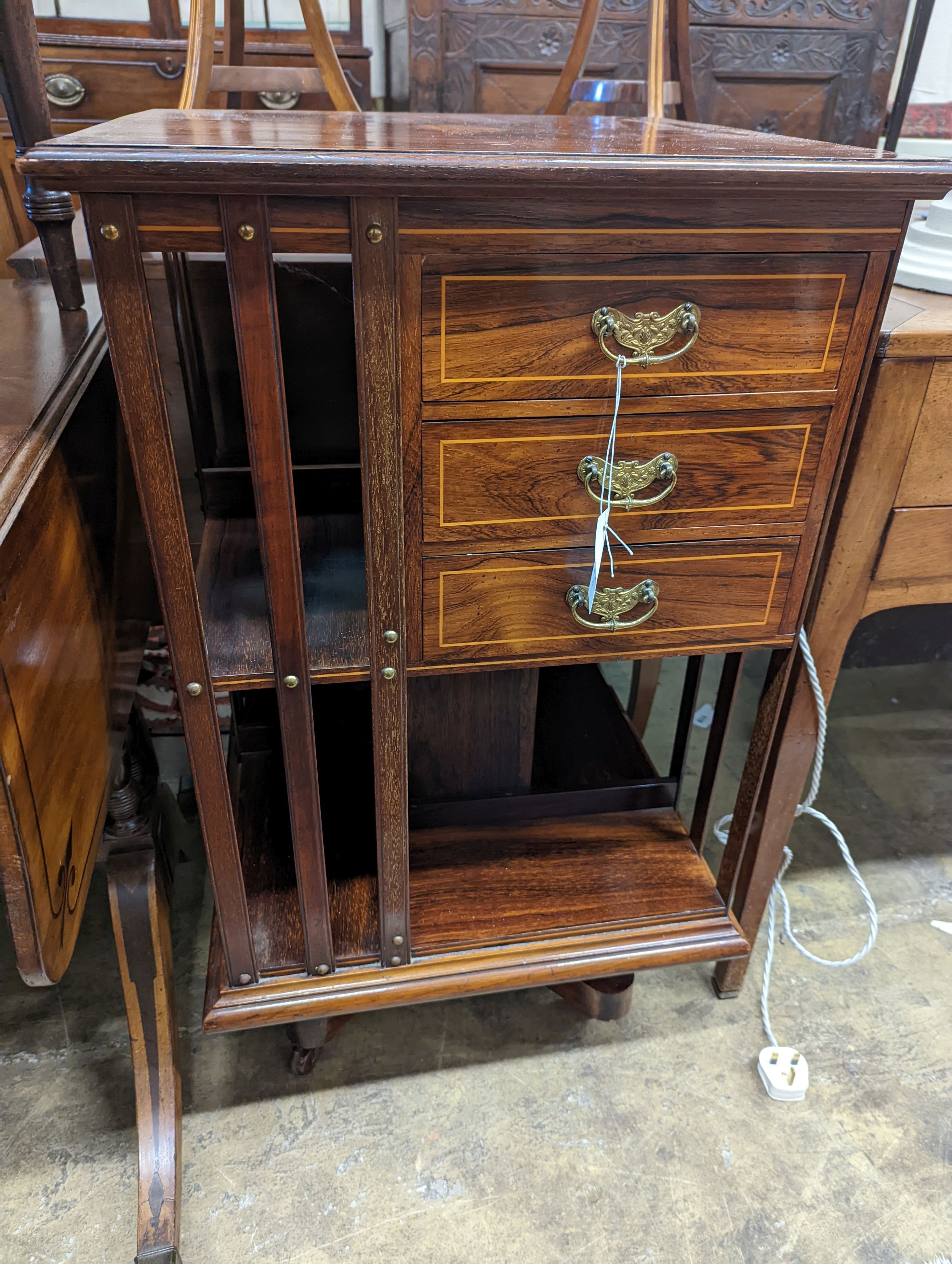 An Edwardian inlaid rosewood revolving bookcase fitted three drawers, width 52cm, depth 51cm, height 88cm